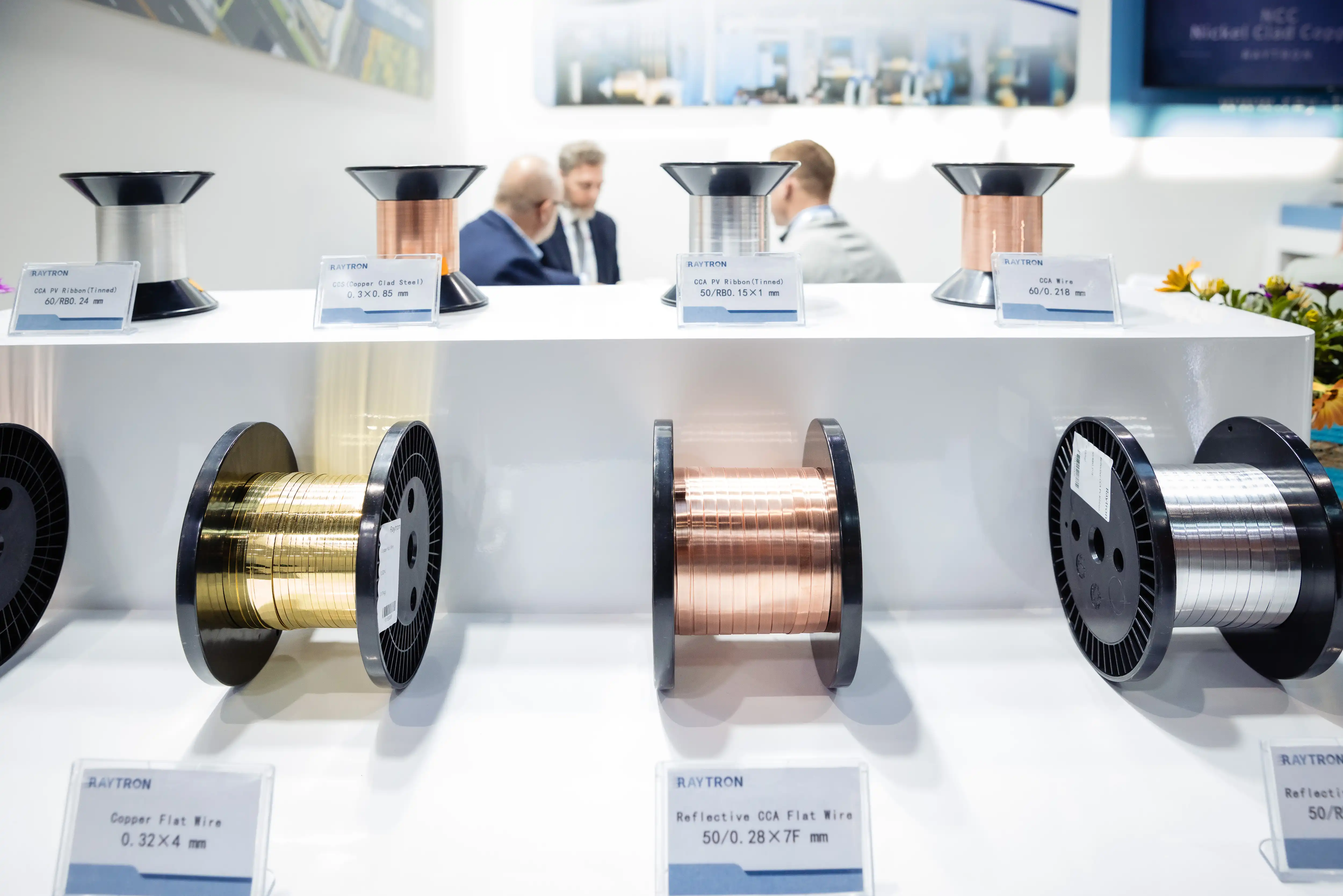 RAYTRON team presenting ultra-thin CCA foil and product specifications to visitors